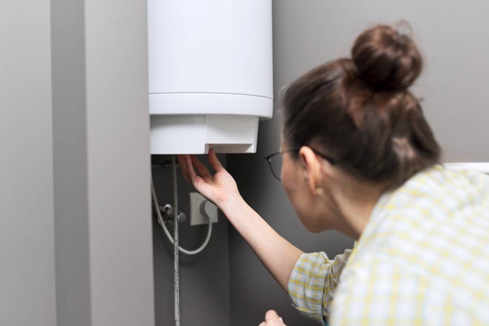 home-water-heater-woman-regulates-the-temperature-2023-11-27-04-57-42-utc-min.jpg