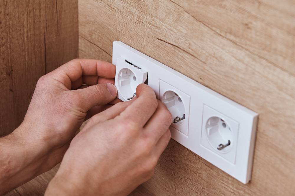 electrician-installing-socket-in-the-kitchen-2023-11-27-05-28-35-utc-min.jpg
